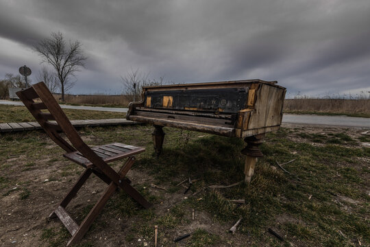 old piano with stook in the nature