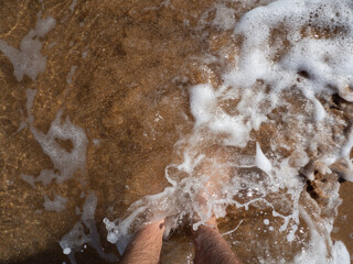 sea waves roll over your feet