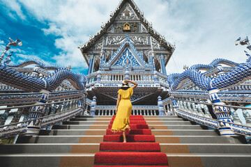 Traveler asian woman with dress travel in temple Thailand