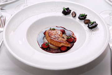 Foie gras with port sauce on table, toned