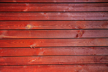Plank backdrop in red with with yellow stains of tree gum.