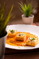 Grilled puff pastry topped with cheddar cheese & garlic butter, oregano seasoning & cilantro for garnish.