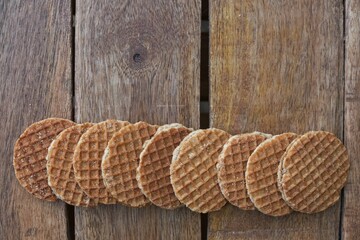 A line of Dutch stroopwafels on wooden table