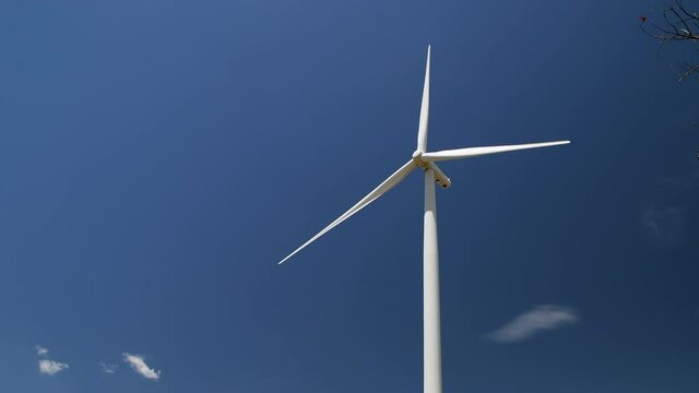 Big Windmills for electric power production on blue sky at Huai Bong, Dan Khun Thot district, Nakhon Ratchasima THAILAND. renewable energy and save  environmental concept.
