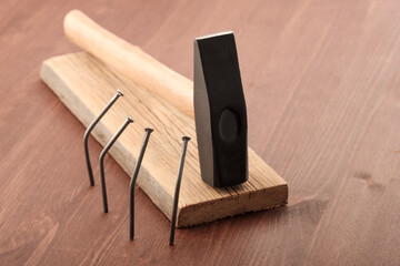 nails bent around a hammer lying on the board. the concept of a tyrant's funeral which is honored by those whom he oppressed