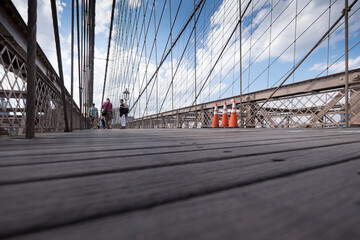 Low angle view of the famous Brooklyn Bridge in New York, USA. One of the most iconic bridges in...