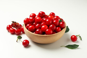 Bowl with fresh red cherry on white background, close up