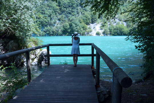 the woman resting thoughtfully in front of the beautiful Lake of Santa Croce in Italy