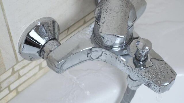 Plumber fixing repairing a leaky shower Bathtub water tap  faucet by wrench tool,  plumbing fix  mount DIY concept. Close up