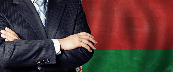 Politics or businessman hands against Belarusian flag background