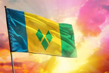 Fluttering Saint Vincent and the Grenadines flag on beautiful colorful sunset or sunrise...