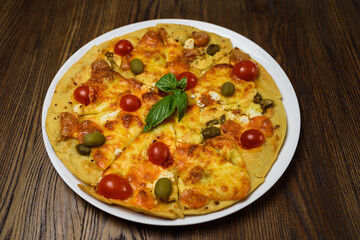 
pizza with meat and tomatoes under cheese