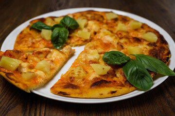 
pizza with meat and tomatoes under cheese
