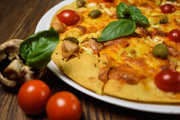 
pizza with meat and tomatoes under cheese