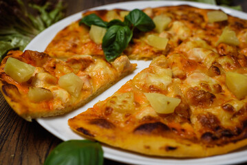 
pizza with meat and tomatoes under cheese