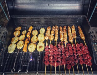 Meats  and potatos on a grill