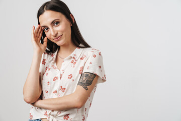Photo of pleased beautiful woman smiling and looking at camera