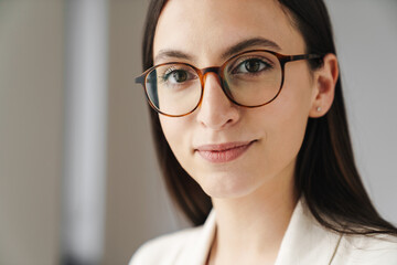 Photo of young businesswoman smiling and looking at camera