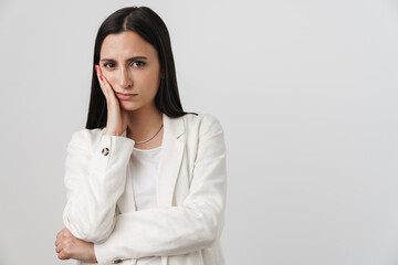 Photo of unhappy businesswoman propping her head and looking at camera