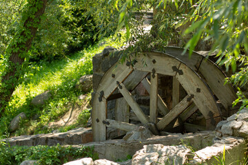 old wooden water pumping wheel on the river