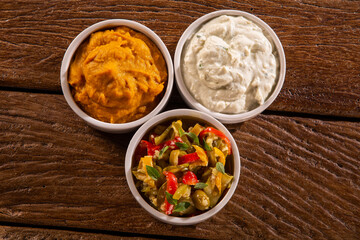 Cooking of zucchini salad, gorgonzola cream and  Pumpkin puree on wood background