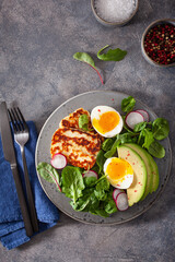 healthy keto paleo diet breakfast: boiled egg, avocado, halloumi cheese, salad leaves