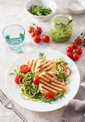 ketogenic paleo diet lunch. halloumi cheese, spiralized zucchini with arugula pesto and tomatoes