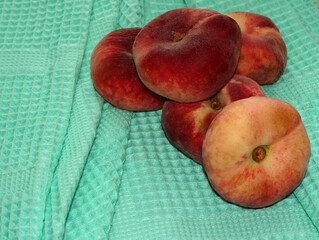 Fig peach on a towel. Fruit on a green cloth.