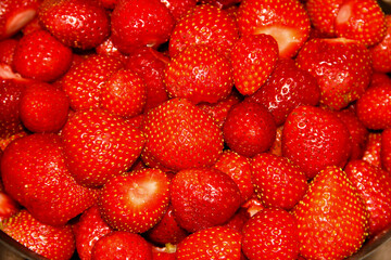 Lots of fresh strawberries. Peeled strawberry fruit.