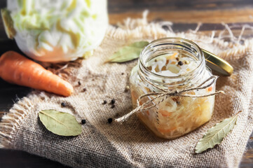 fermented vegetables on wooden background and sackcloth