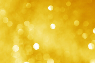 abstract defocused yellow bokeh sparkling light glitter background. for wallpaper backdrop and template.