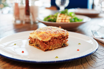 Moussaka and fried feta cheese, toned