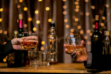 Barman pouring whiskey glass beautiful night