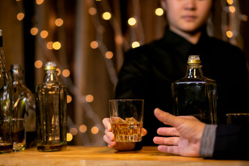 Waitress man pouring wine into glass