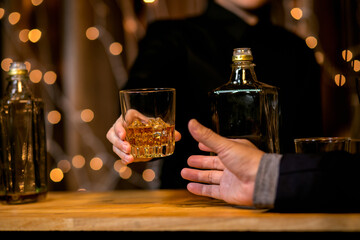 Barman pouring whiskey glass beautiful night