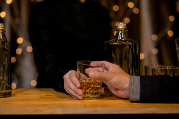 Barman pouring whiskey glass beautiful night