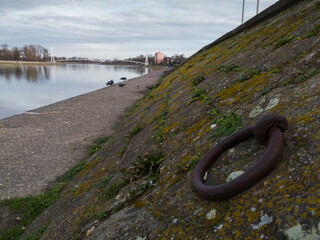 Pedestrian bridge on the Drava in Osijek. Landscaped shore with alcove for mooring boats.