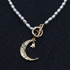 Golden crescent moon pendant with pearl necklace