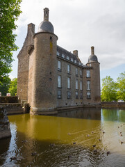 The castle of Flers, now a history museum (Normandy, Orne, France). Beautiful medieval architecture. Vertical picture of this historical monument. Surrounded by a moat. Sunny day.