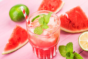 Watermelon summer cocktail with ice and mint leaves.