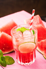 Watermelon summer cocktail with ice and mint leaves.