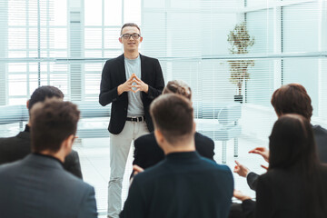 speaker showing the business team a graph with financial data