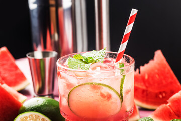Watermelon summer cocktail with ice and mint leaves.