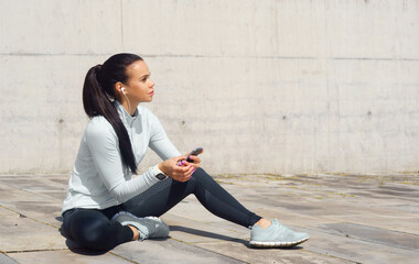 Young and sporty brunette woman training outdoor. Fitness, sport, lifestyle and health care.