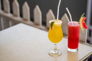 Glasses of antioxidant watermelon juice and orange juice decoration with plastic straw in a restaurant in Bali