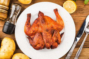 Fresh roast chicken on a wooden board background