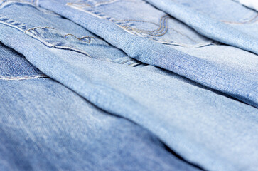 Denim texture. Texture of ripped light blue jeans.
