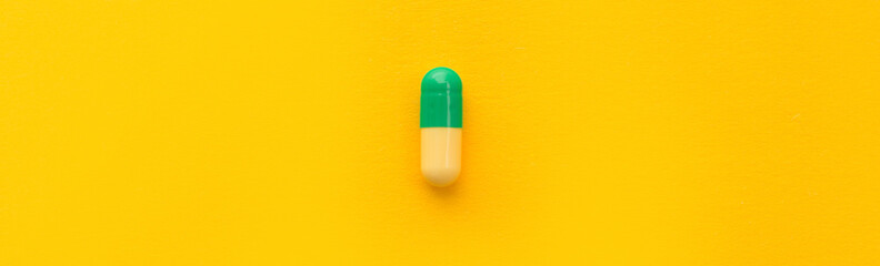 Pharmaceutical medicine pills, tablets and capsules on yellow background. Top view. Flat lay. Copy space. Medicine concepts. Minimalistic abstract concept. Neo mint color