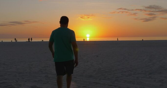492 Man on the beach walking into the sunset