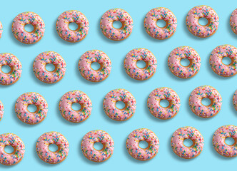 Summer pattern made with pink donuts on light blue background. Summer concept